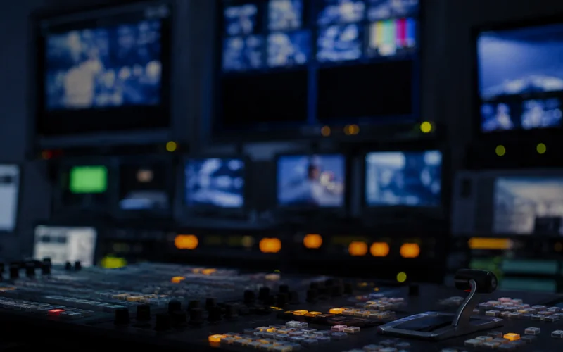 Out-of-focus broadcast monitors in a studio